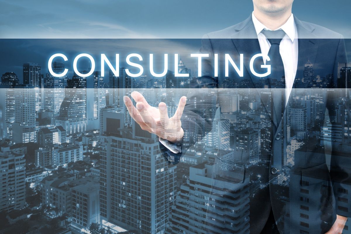 Double exposure of professional businessman with night cityscape in blue tone hold CONSULTING word in business concept